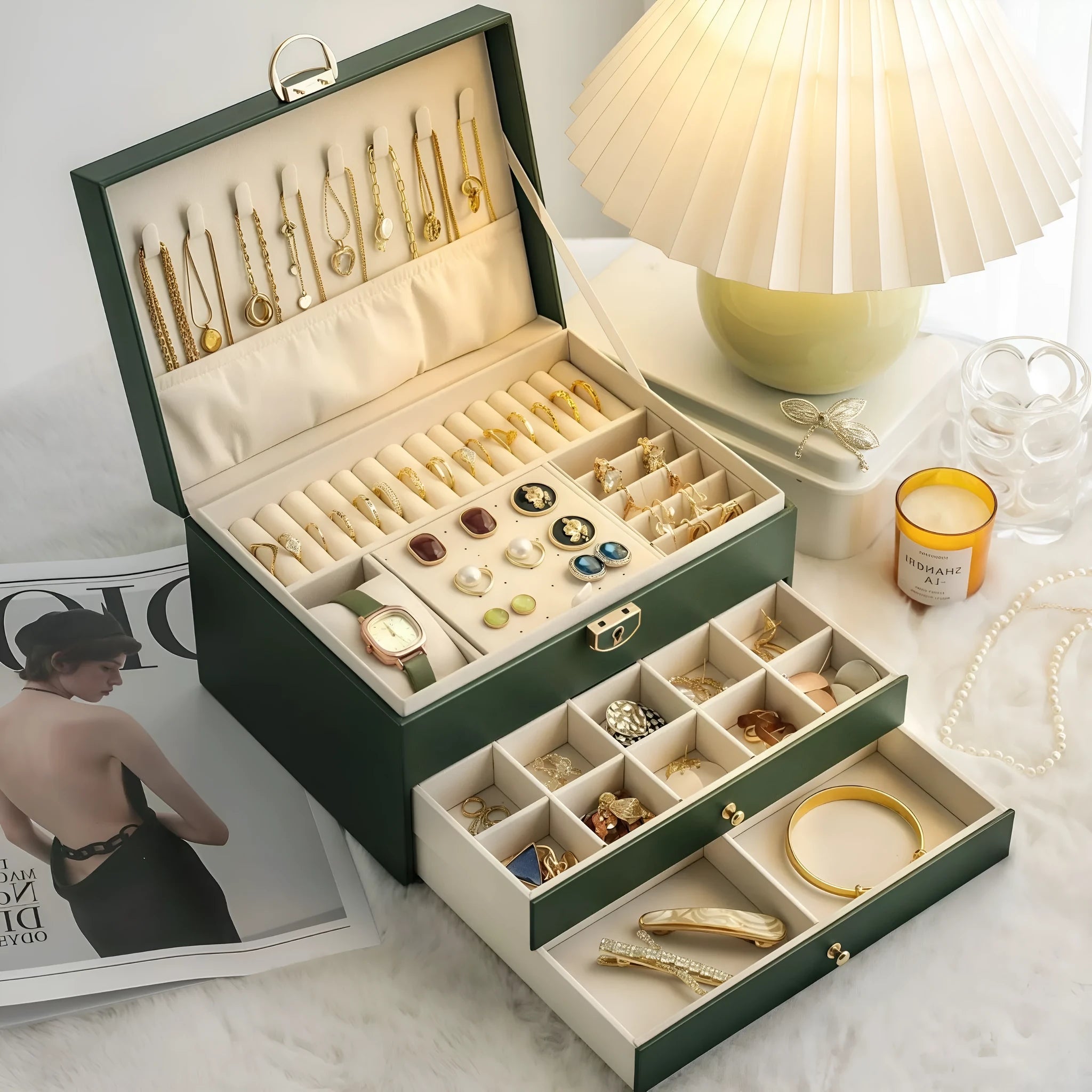Leather jewellery box with three drawers open, showing storage for necklaces, earrings and bracelets.