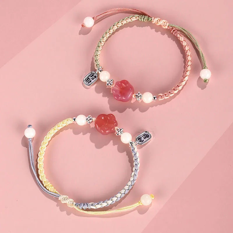 Handmade glass cat paw couple bracelet with red charm on pink or yellow woven cord