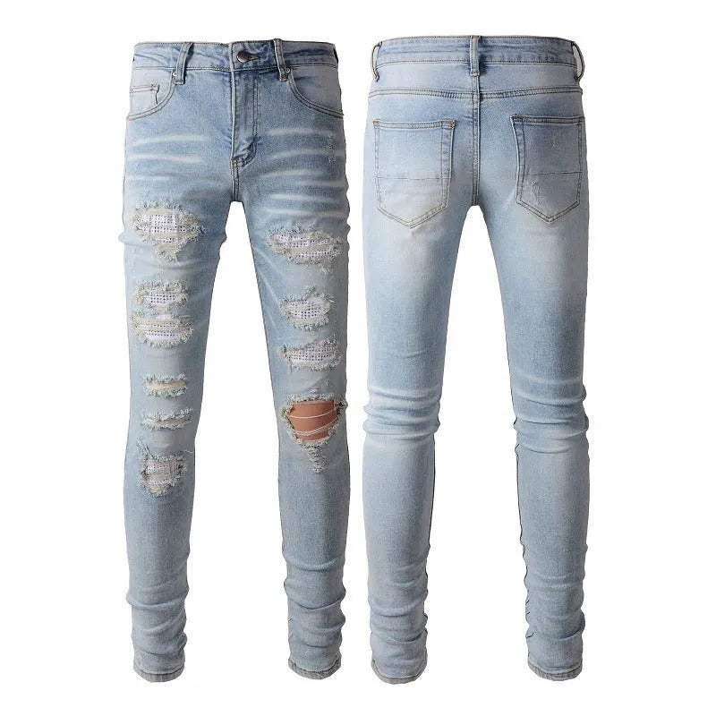 Light blue slim fit men's jeans with patch details, holes, and enzyme-washed finish