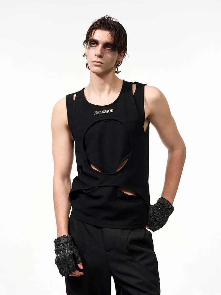 Man wearing a black sleeveless pullover waistcoat with a round neck, showcasing the loose fit and hollow thread texture.