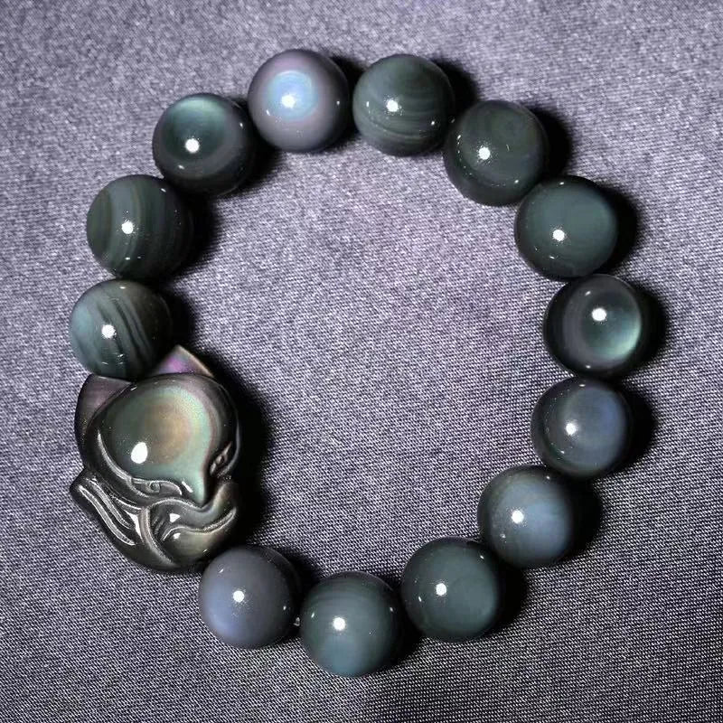 Black obsidian fox carved bracelet showing detailed animal design on polished gemstone