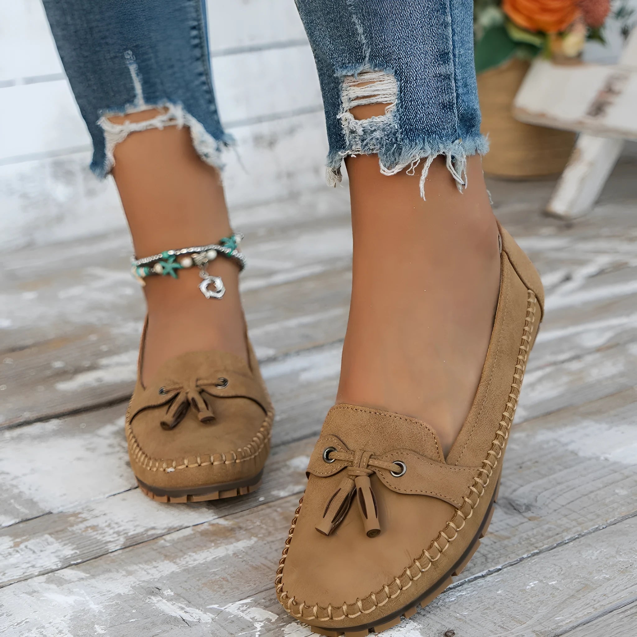 Women's suede flat shoes with a decorative bow in apricot colour