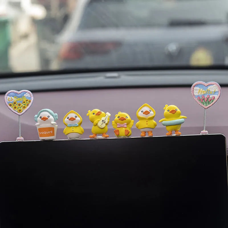 PVC cartoon duckling car decoration set with six ducks and one sign on a car dashboard