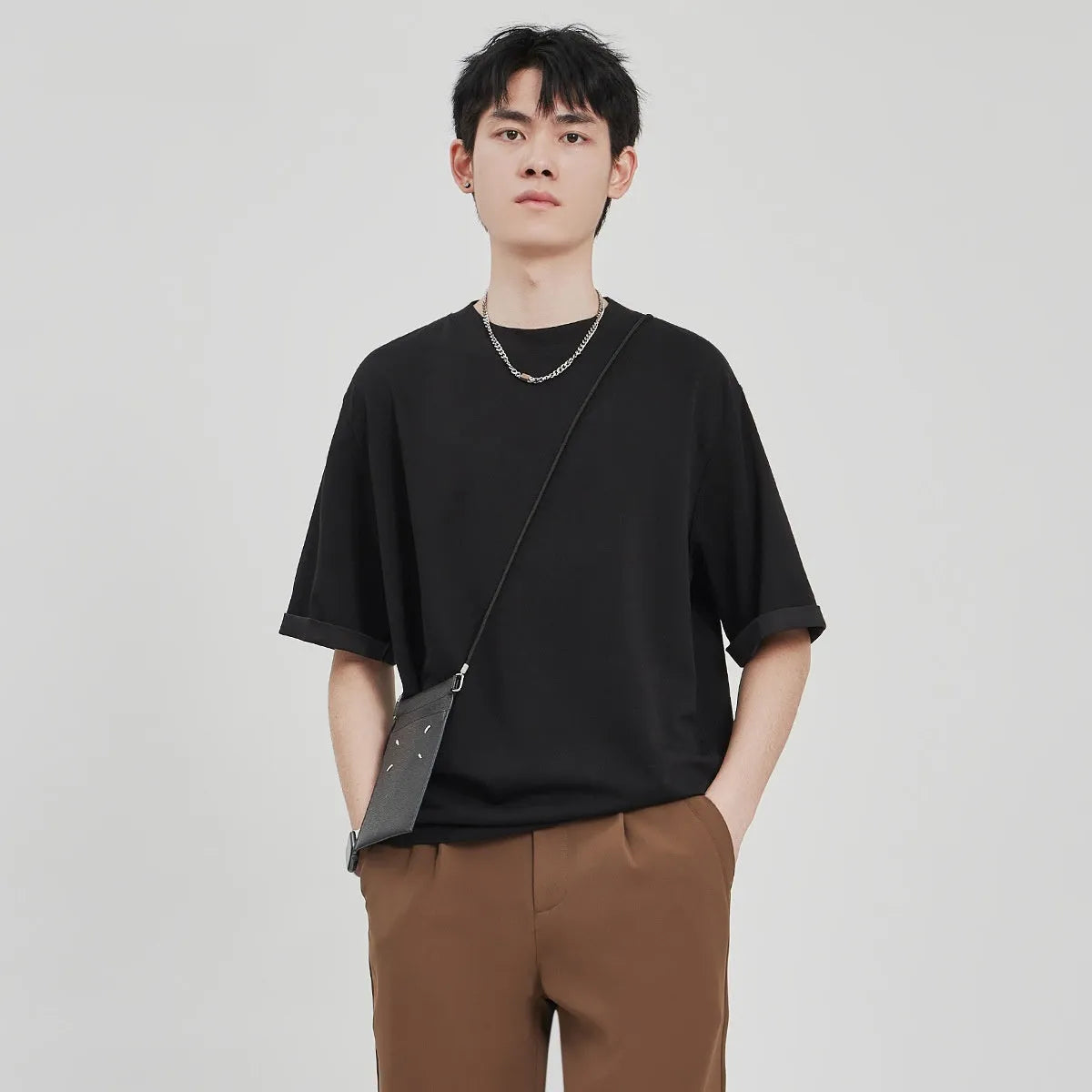 Men's loose fit drape knit T-shirt in polyester blend fabric available in black, brown, and white colours