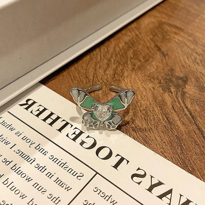 Copper butterfly women's ring with dripping oil texture and an open loop design.