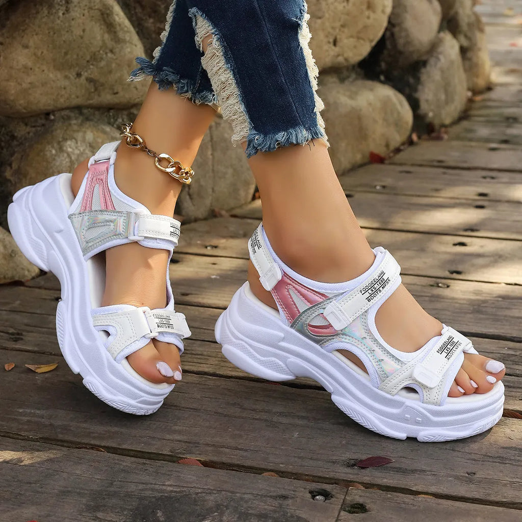 Women's black Roman platform sandals with secure strap design on white background