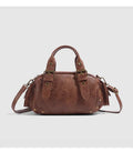 Brown artificial leather motorcycle bag with single shoulder crossbody strap and horizontal square retro shape