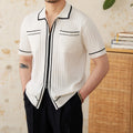 Slim fit black knitting polo shirt with short sleeves and a lapel collar laid flat.
