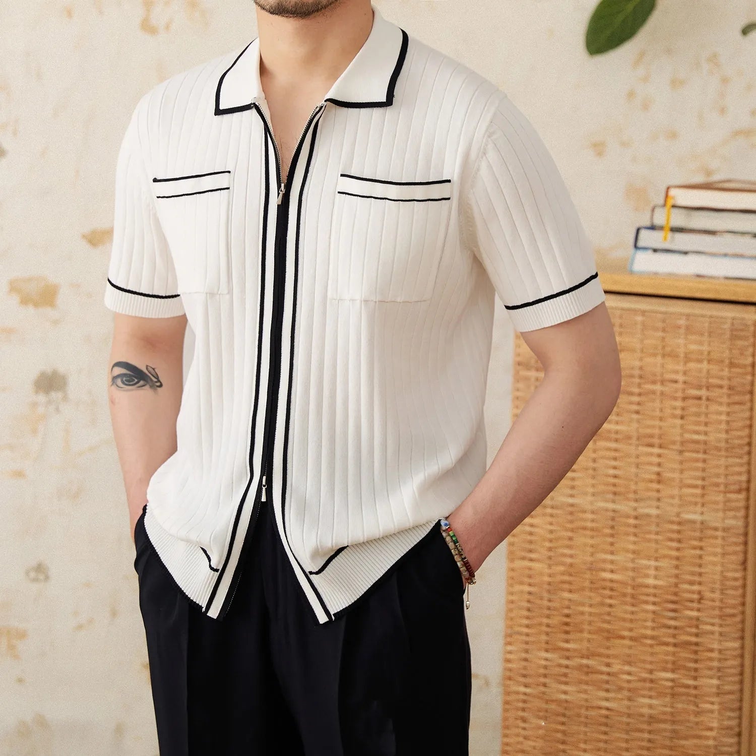Slim fit black knitting polo shirt with short sleeves and a lapel collar laid flat.