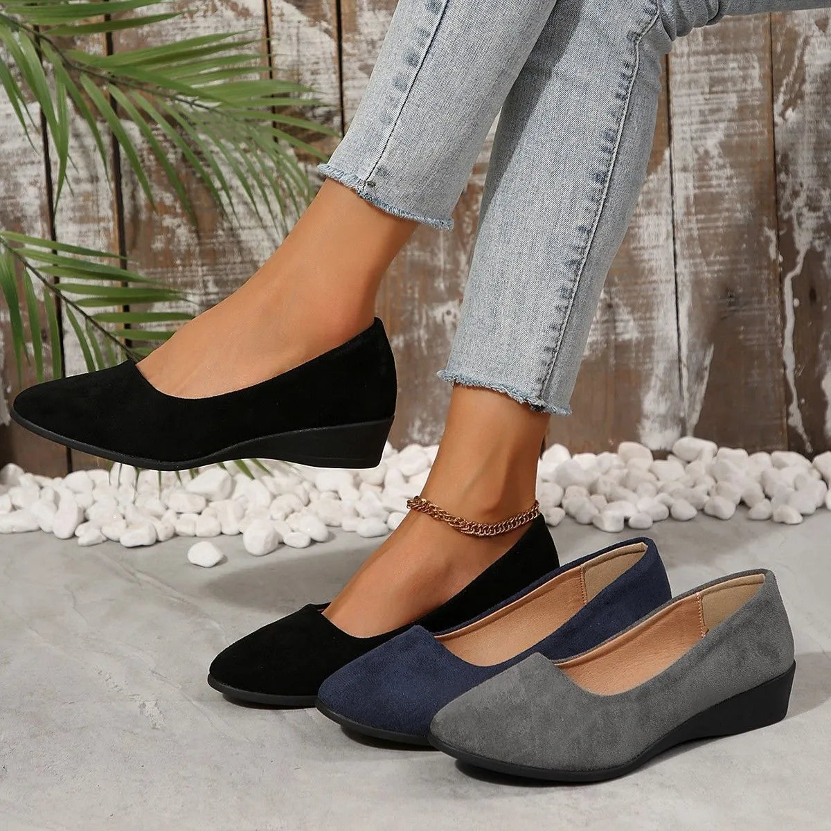 Women's plus size pointed toe wedge pumps in suede with a shallow cut and low rubber heel.