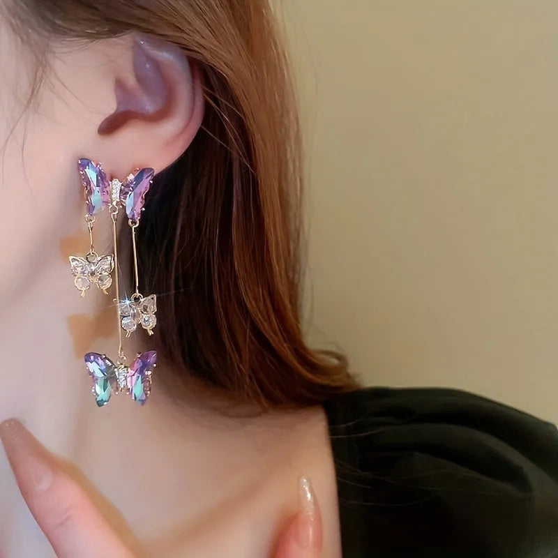 A pair of silver needle-blue purple butterfly tassel earrings with crystal flowers on a 4.5cm drop.