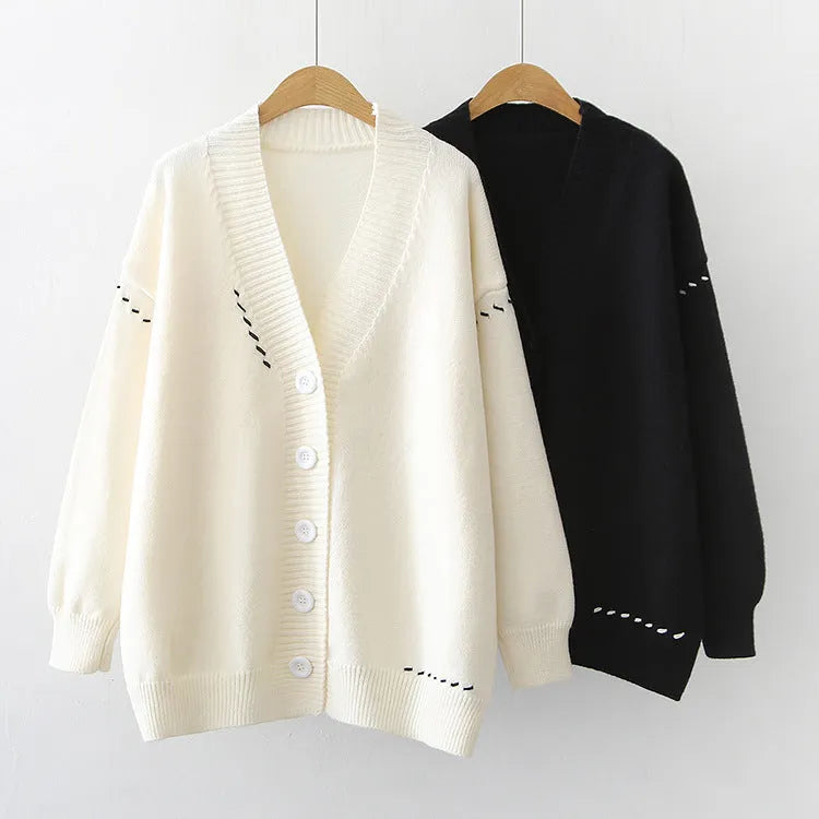 Loose fit black knitted cardigan coat with long sleeves, shown open as a casual layer.