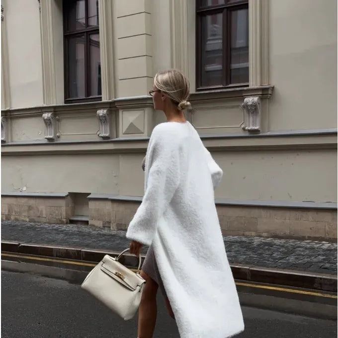 White oversized knitted cardigan jacket with long sleeves on a model.