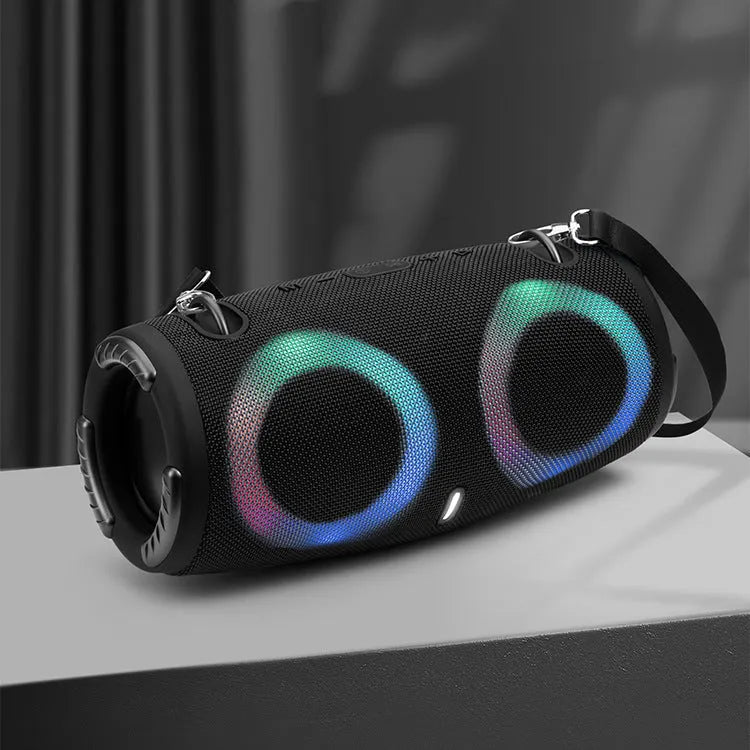 War Drum portable Bluetooth speaker with coloured RGB lights in camouflage colour, showing carrying strap and control buttons.