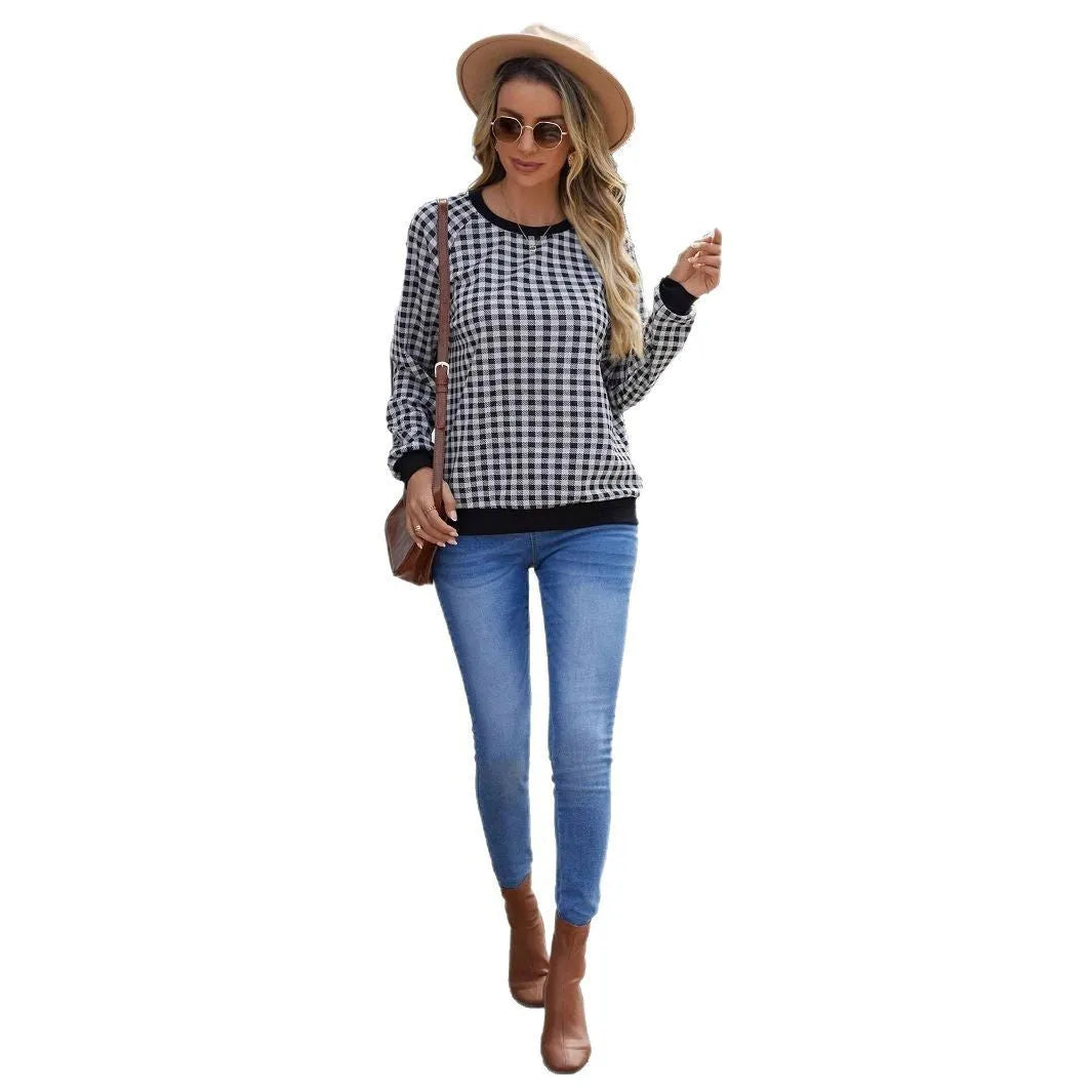 Black polyester pullover sweater with a plaid and printed stripe pattern, long sleeves.