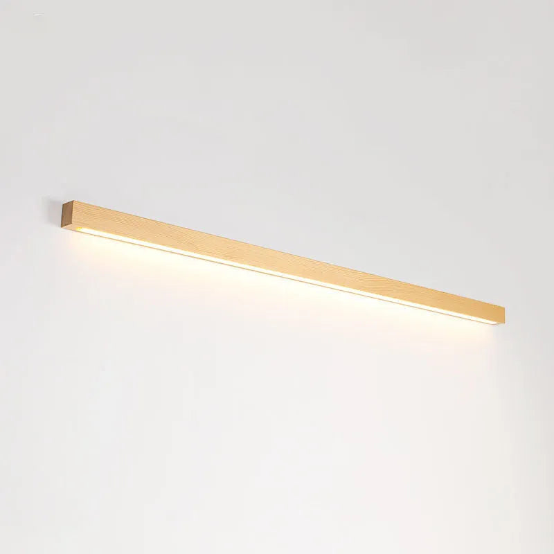 Modern walnut-coloured log strip wall lamp in three sizes on a white wall.