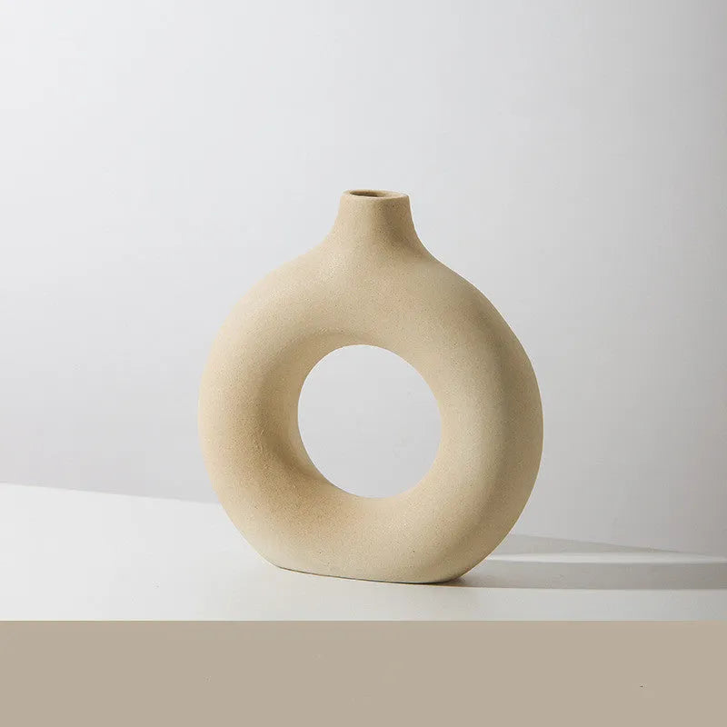 Frosted unglazed porcelain biscuit vase in a simple modern style on a table.
