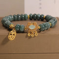 Women's bracelet with green jade abacus beads and a metallic safety lock clasp.