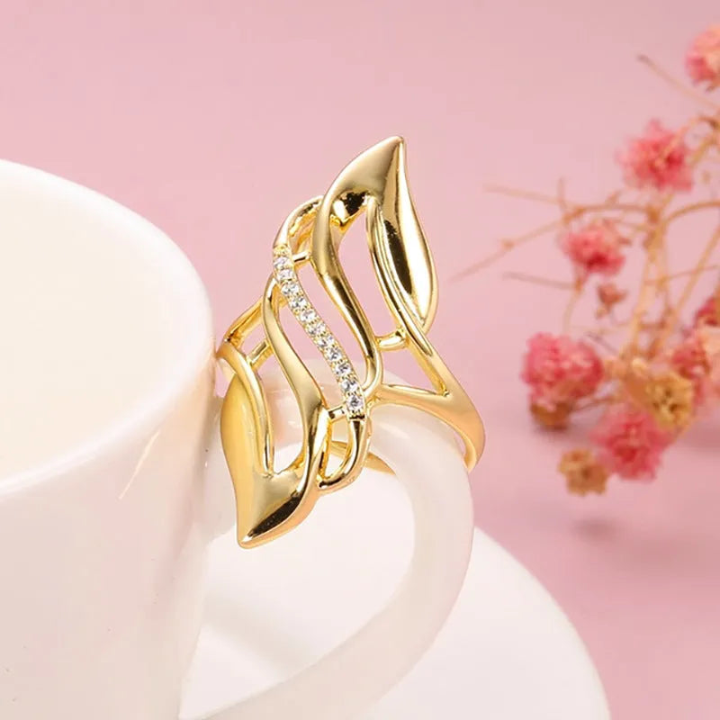 Women's copper ring with exaggerated curve design in Q611 gold colour showing side profile