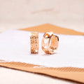 Pair of rose gold women's earrings with a 1.5cm hollow heart shape and three smaller heart cut-outs.