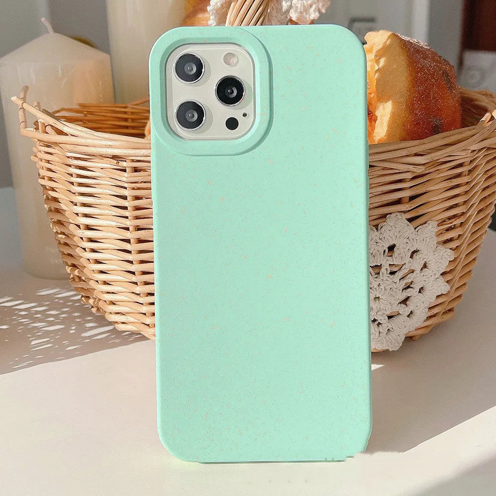 A degradable wheat straw phone case for iPhone on a wooden surface, showing its rear cover design.