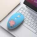 Colourful wireless mouse with cartoon animal designs next to laptop showing compact size