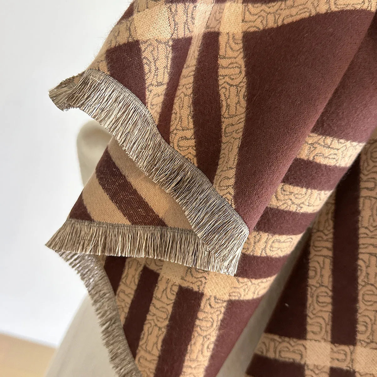 Qianjin mid-length brown imitation cashmere scarf with tassels laid flat showing 185cm length.
