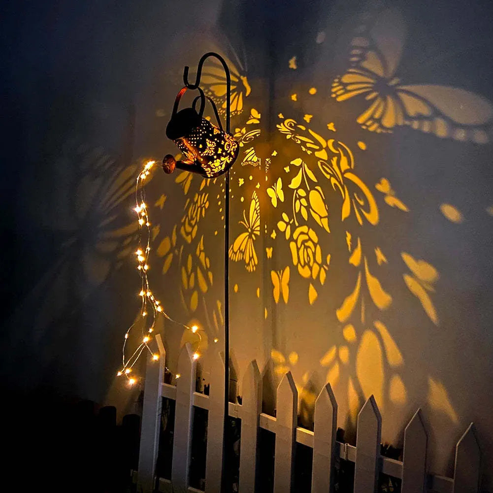 Solar-powered iron garden lamp with a tapered butterfly design and warm white LED light.