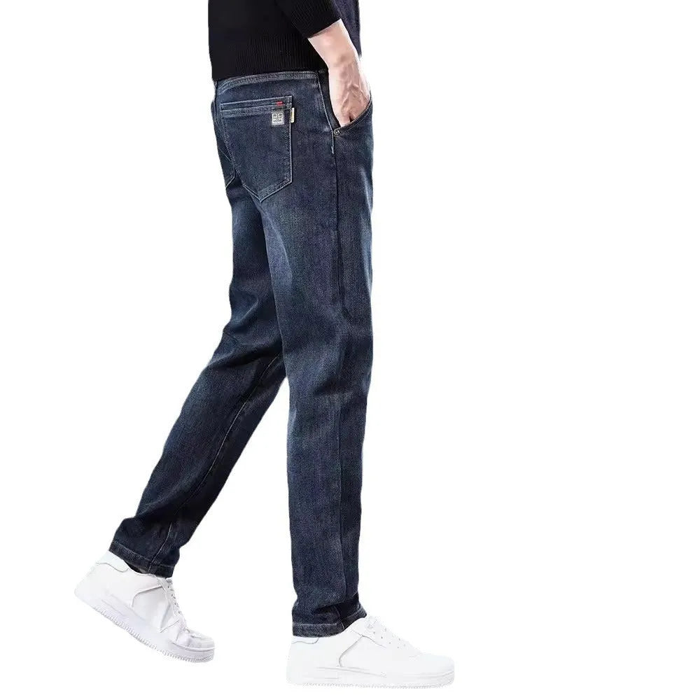 Man wearing slim straight blue grey casual trousers with a zipper fly and mid waist.