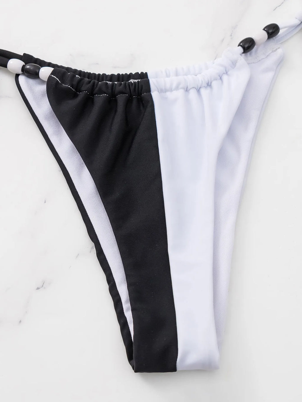 Black and white lace-up triangle bikini set for women, shown as a complete two-piece swimsuit.