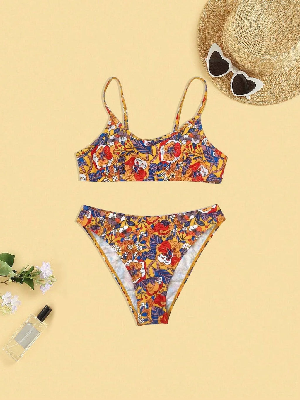 Plus size women's floral print strap bikini swimsuit set in brief style on a mannequin