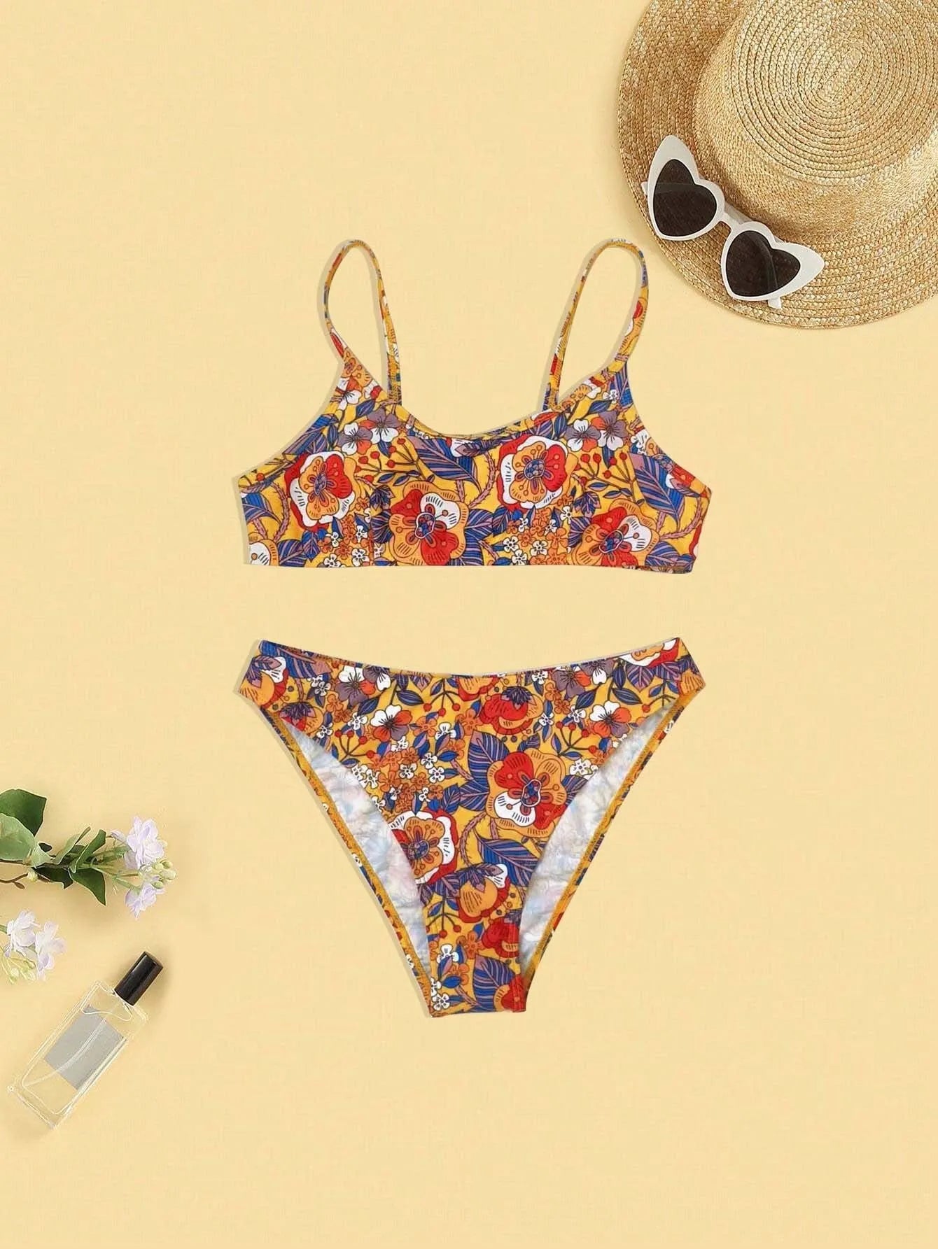 Plus size women's floral print strap bikini swimsuit set in brief style on a mannequin