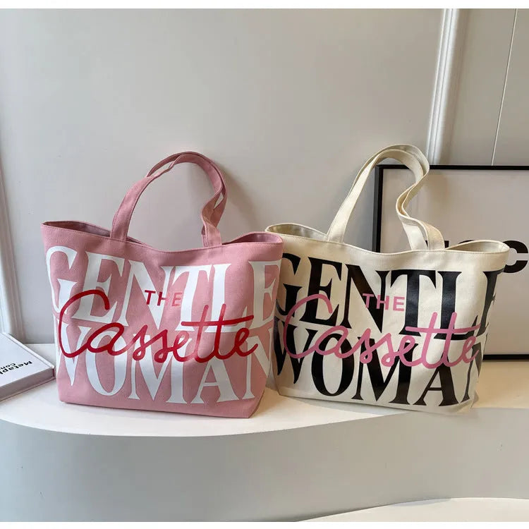 Canvas tote bag with letter print and car stitching detail in medium size 40x7x32cm available in black