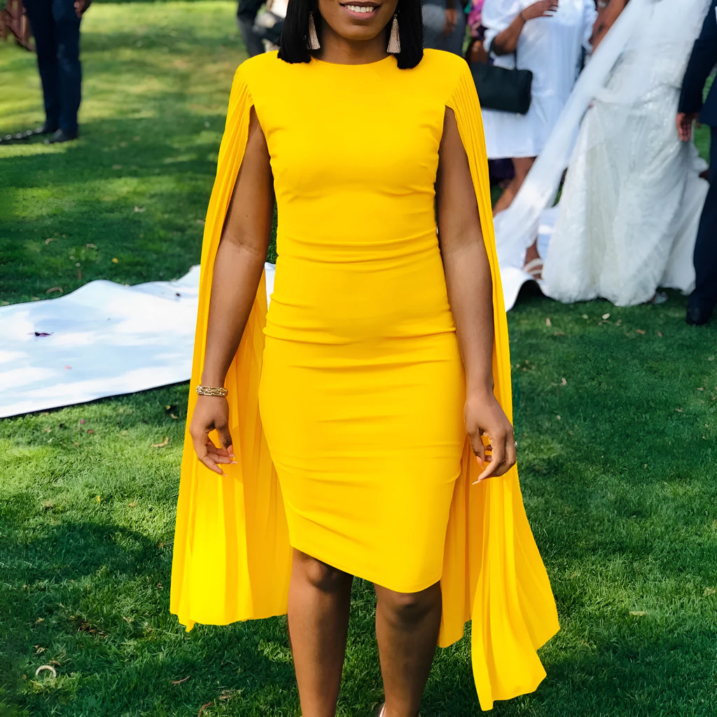 Yellow high-waist long sleeve evening gown with round neck and pleated skirt on a mannequin