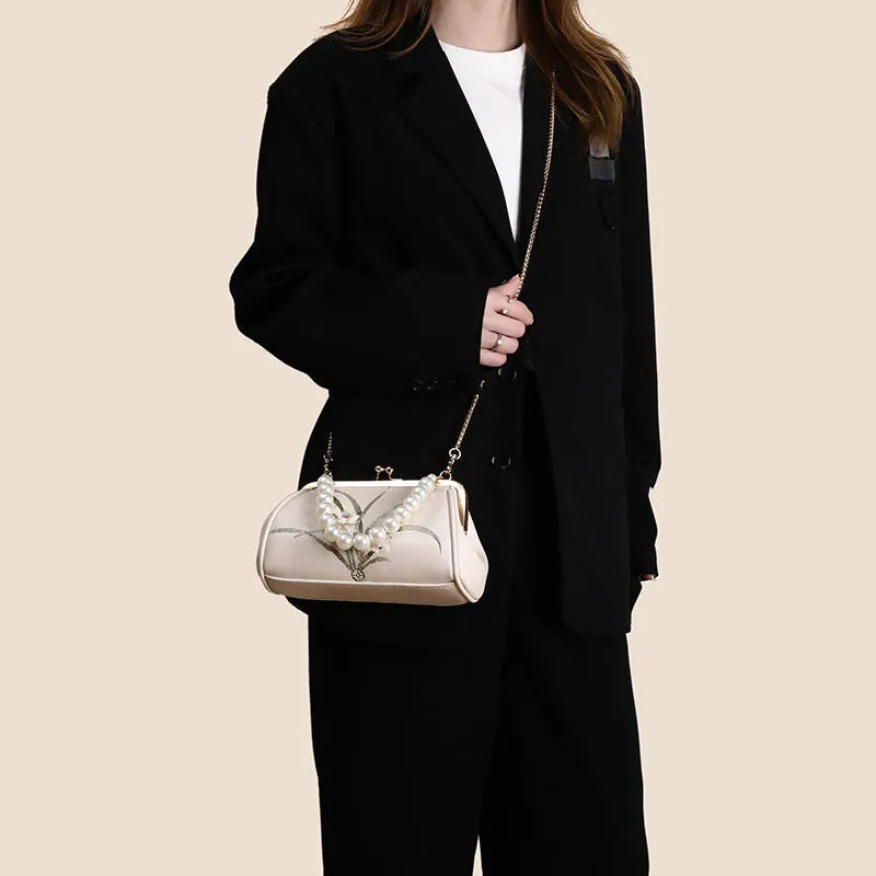 Beige women's shoulder bag with embroidery on soft PU leather in shell shape