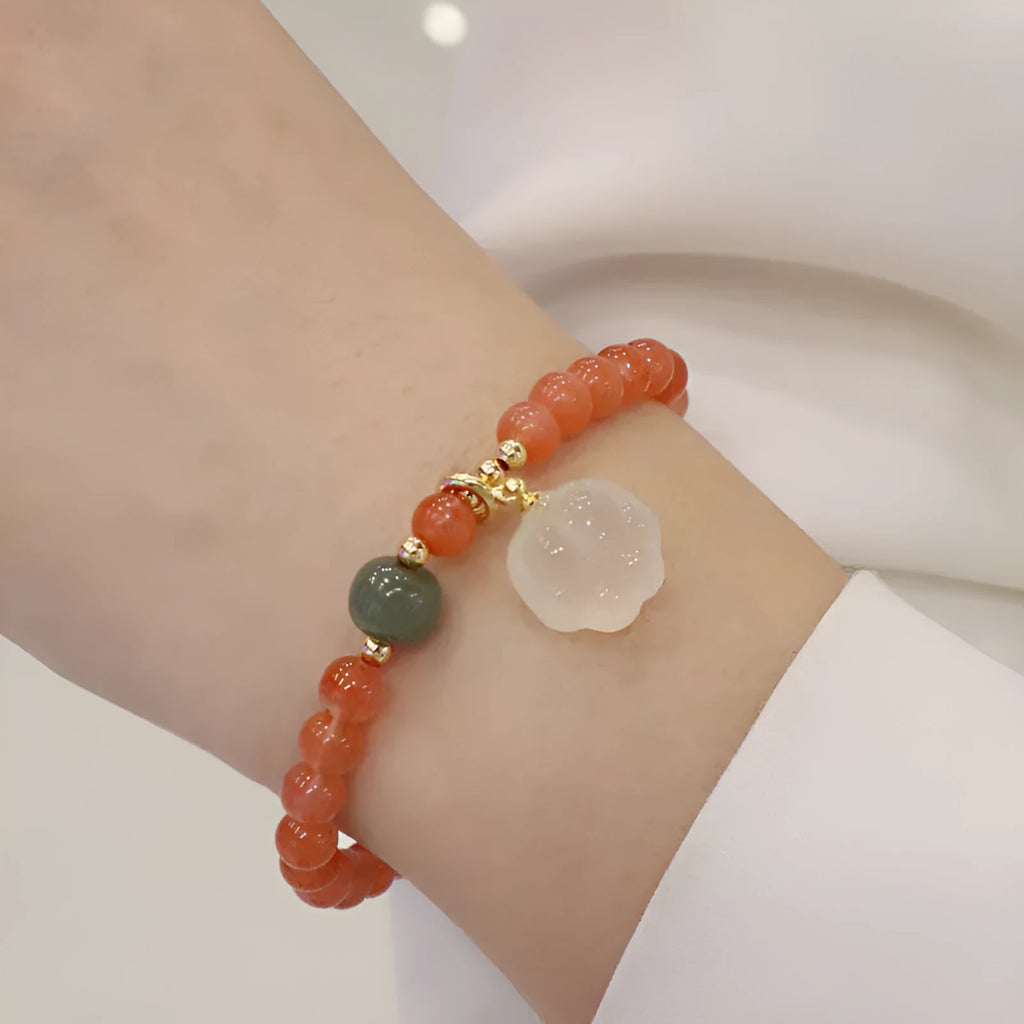 Women's red agate bracelet with 6mm beads and 8mm cat's paw design element