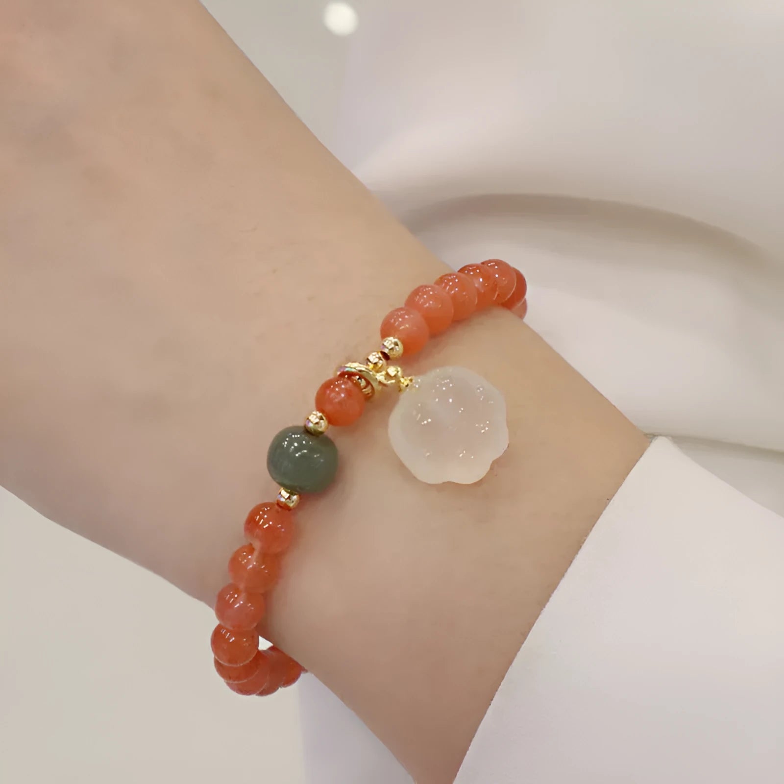 Women's red agate bracelet with 6mm beads and 8mm cat's paw design element