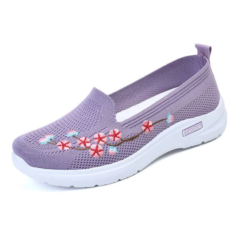 Women's wine red embroidered low heel pumps with round toe and anti-slip sole.
