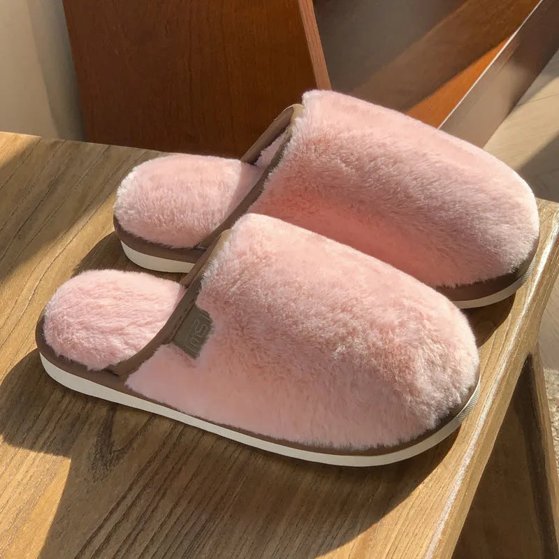 Winter plush slippers in blue with non-slip PVC sole and car stitching detail on the upper.