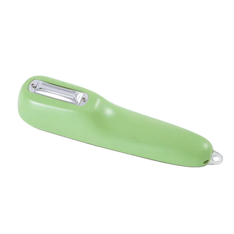 Dark green potato peeler with a stainless steel blade stored inside a clear plastic tube, next to its storage box.