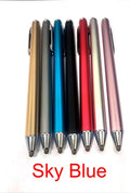 A black metal stylus with a fine point tip positioned next to a mobile phone and tablet on a desk.