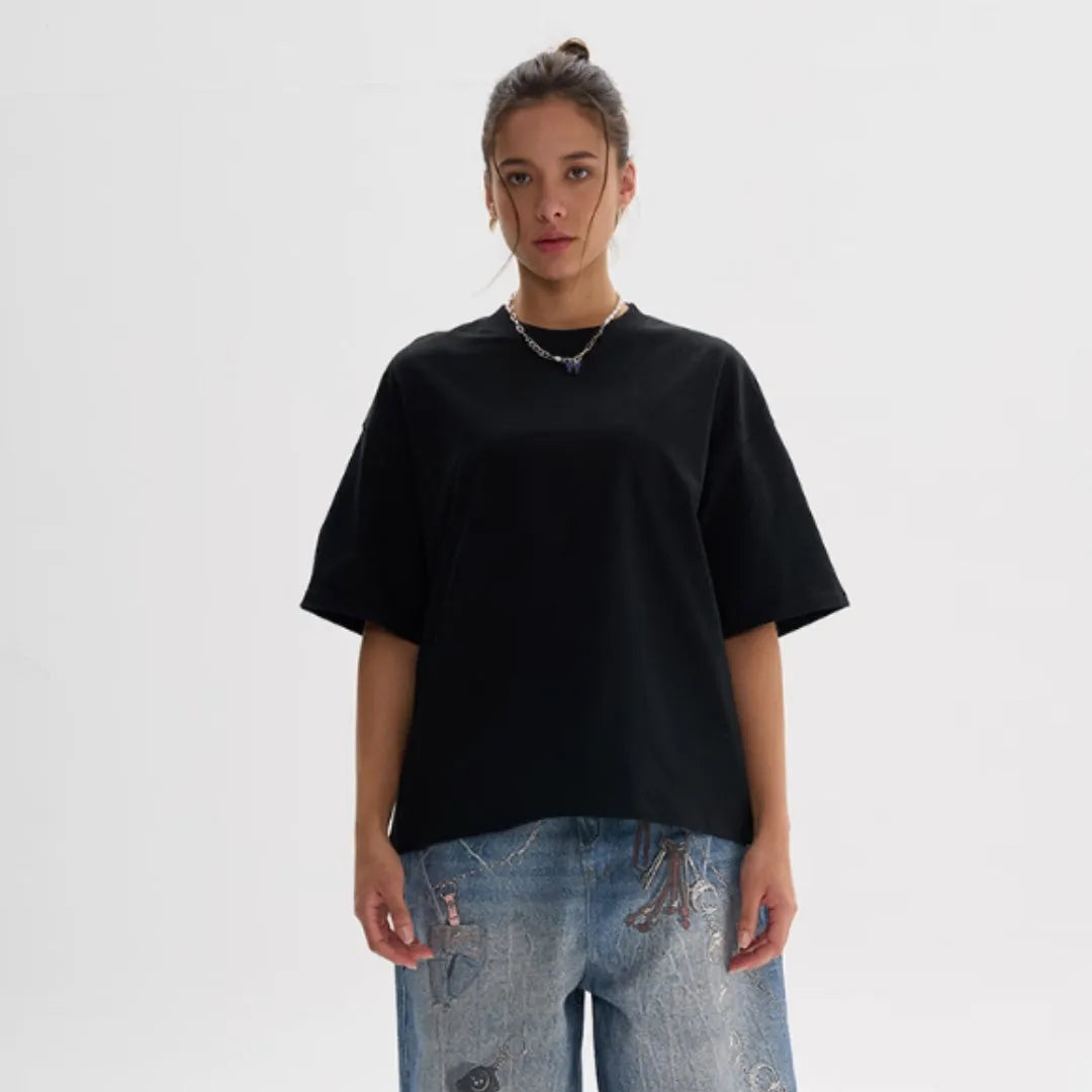 A pure cotton loose fit short-sleeved T-shirt shown in an apricot colour on a hanger.