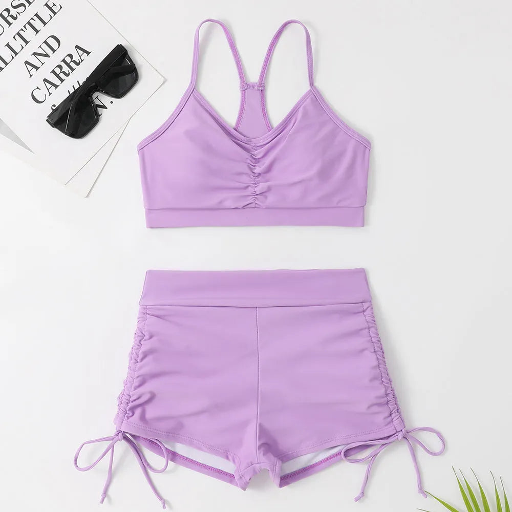 A purple high-waist split swimsuit for women, showing the bikini briefs style and sleeveless design.