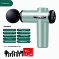 Konka V19 grey professional electric massage gun with multiple silicone massage heads on a table