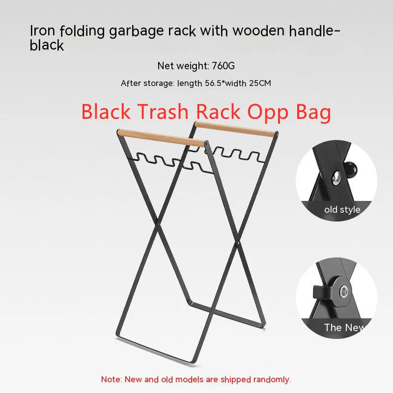 Outdoor black iron folding garbage storage hanger with wooden handle holding a bin bag.