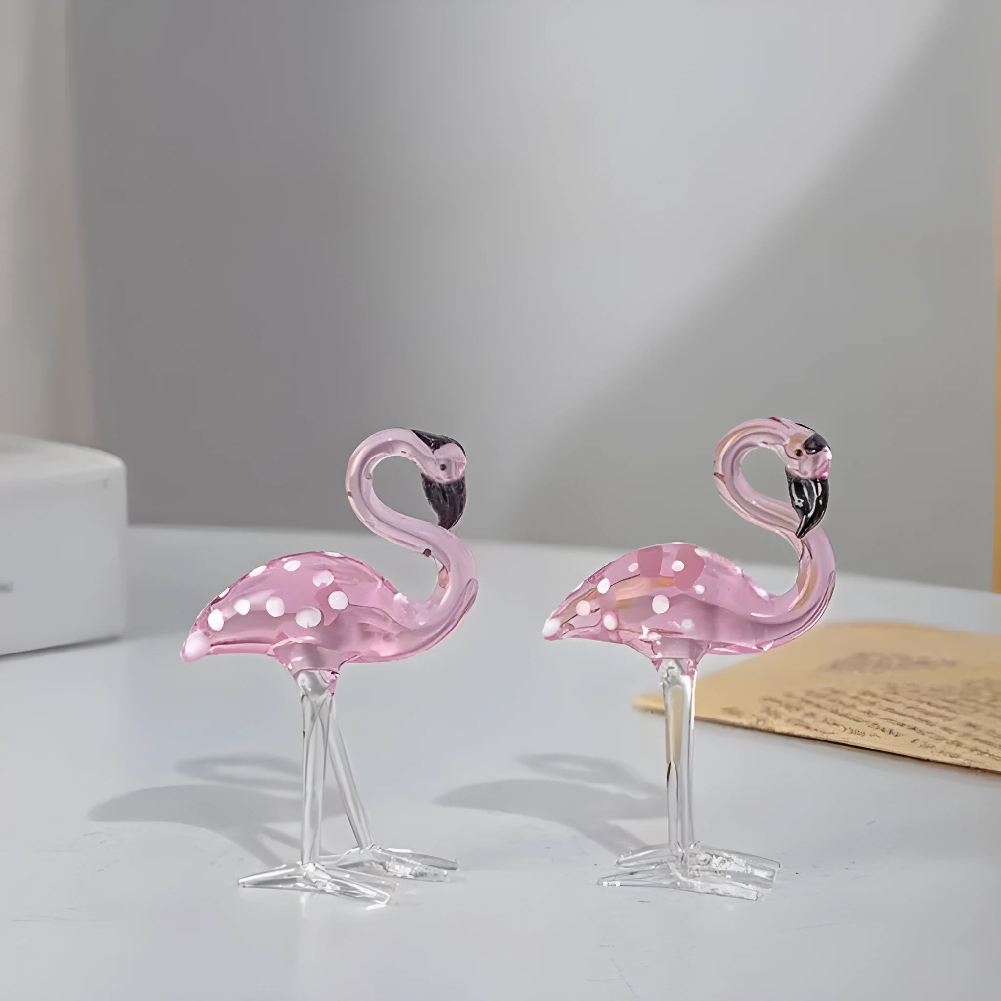 Pink crystal flamingo decorative figure on a table in modern style.