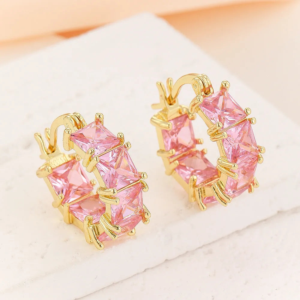 Geometric U-shaped gold earrings with black crystal zirconium stones in round design