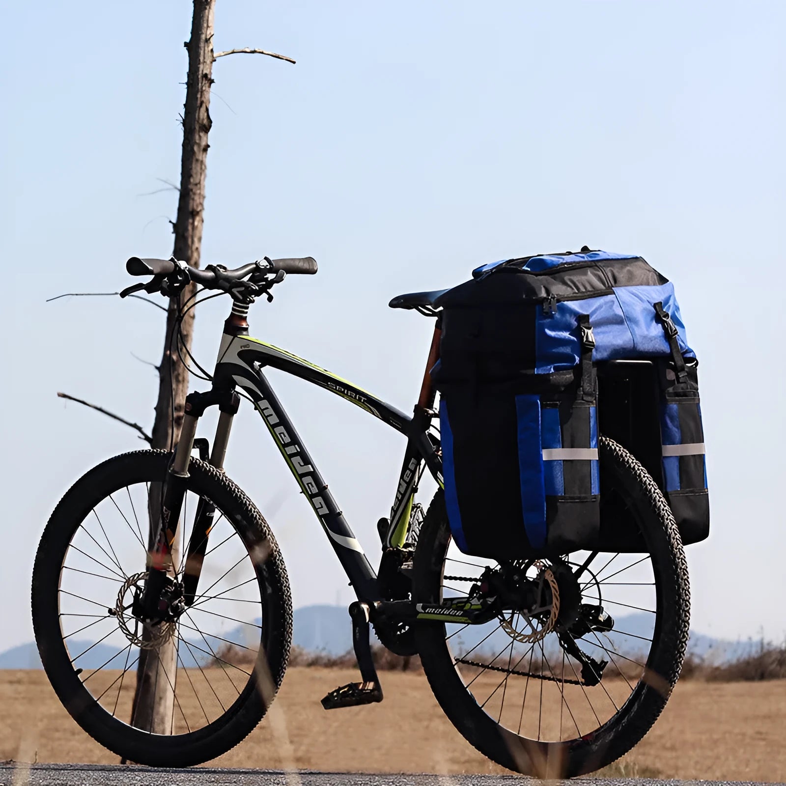 Rhinoceros green 70L bicycle rear storage frame bag mounted on a touring bike.