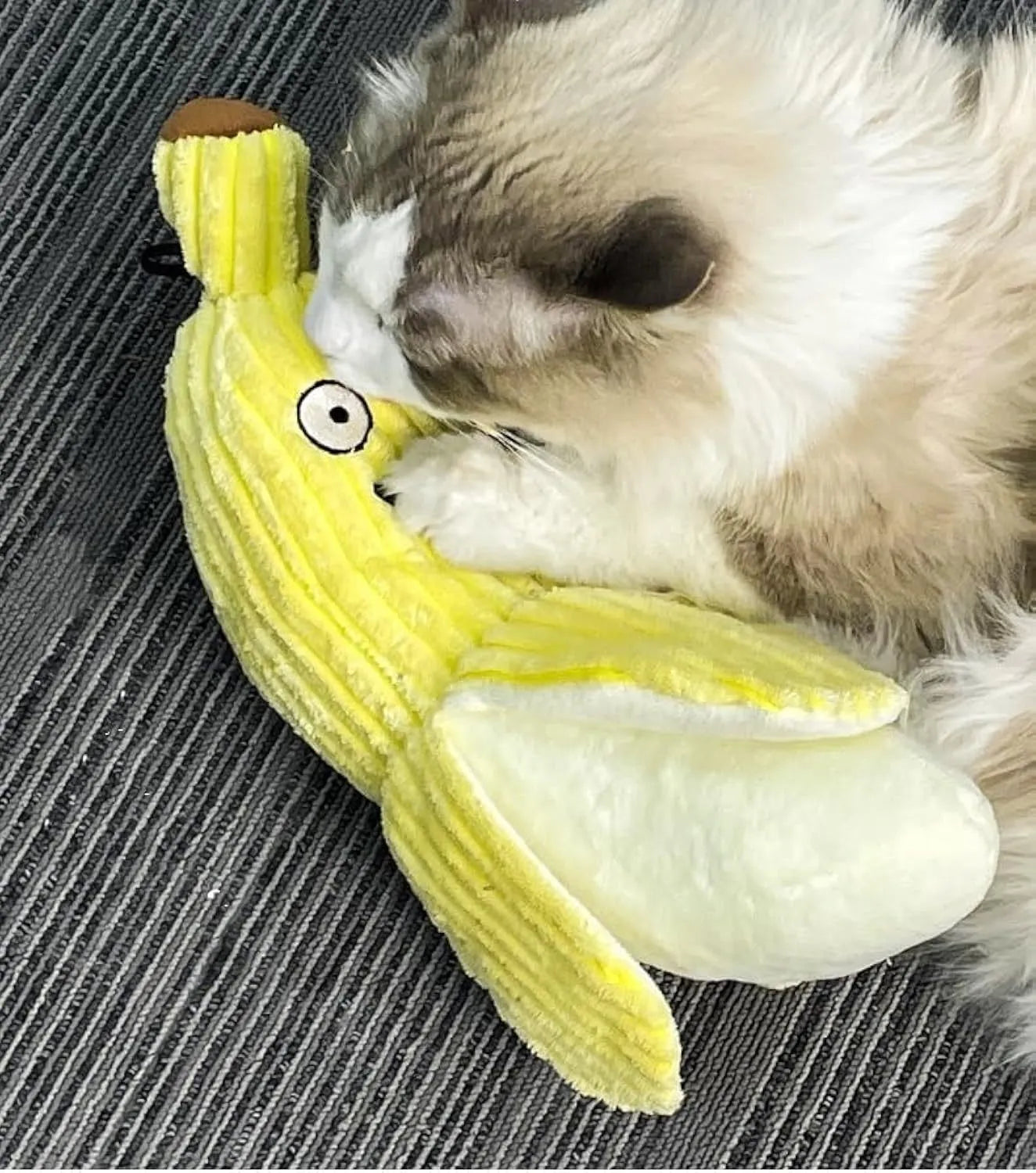 Yellow banana-shaped cat toy with textured surface measuring 13 inches long