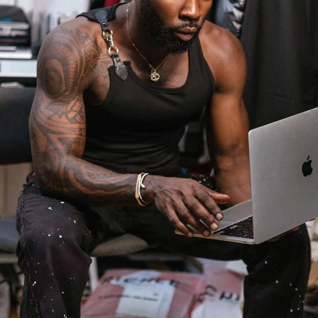 A man's tight-fitting sleeveless vest in solid black or white cotton blend fabric.